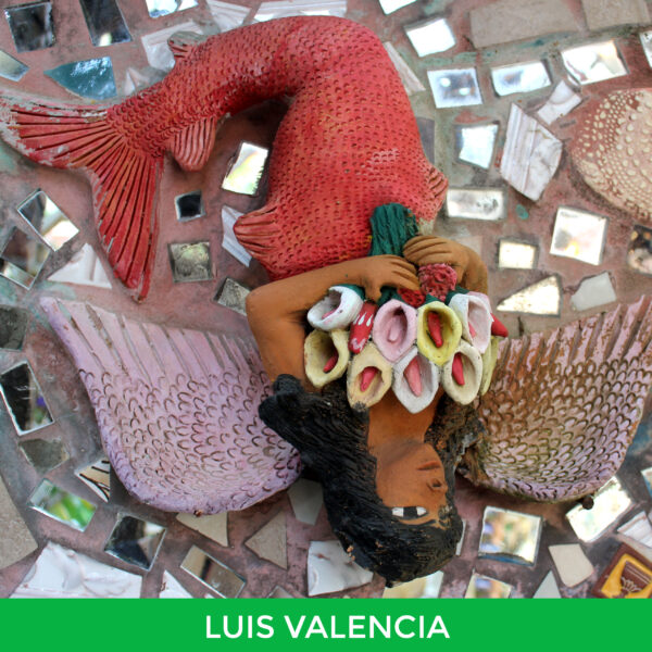 An upside-down painted ceramic mermaid with angel wings by Luis Valencia.