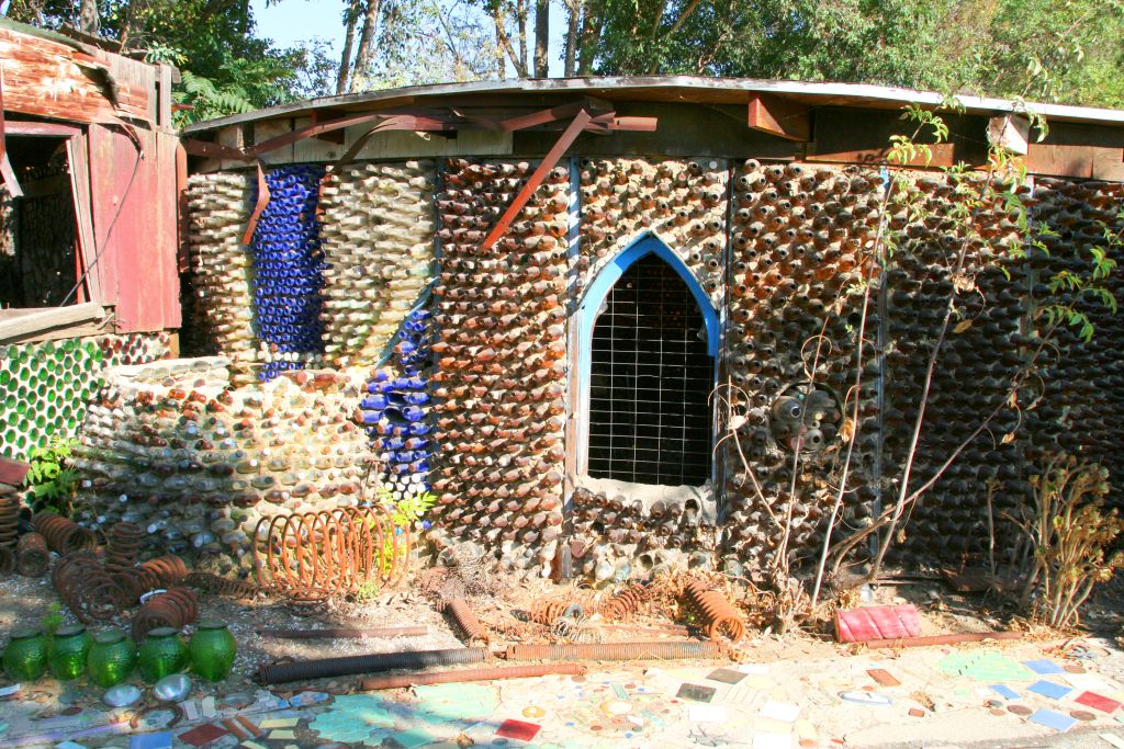A round building with walls made out of empty glass bottles.