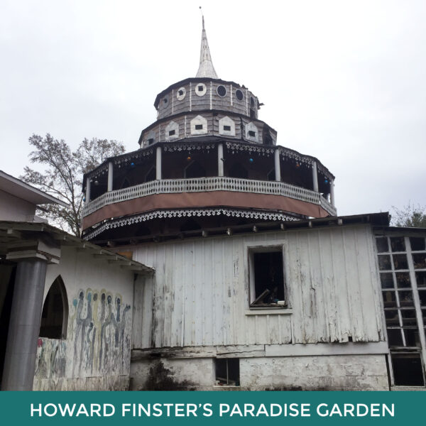 Howard Finster’s Paradise Garden. A large white building with a rounded top and spire on the roof. 