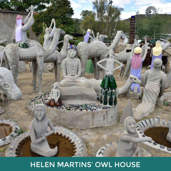 Helen Martins’ Owl House. Cement sculptures of people and animals in an outdoor space. Some are decorated with bottles and broken glass. 