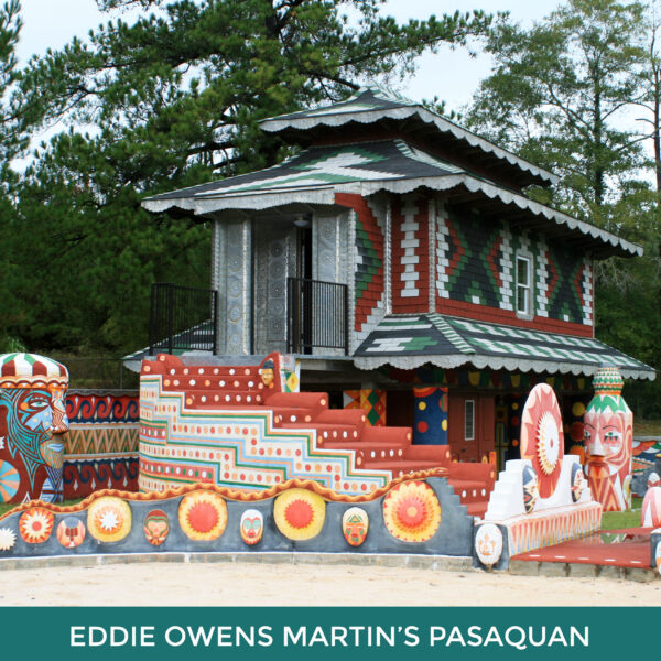 Eddie Owens Martin’s Pasaquan. A small building and undulating low wall painted with patterns and colors.