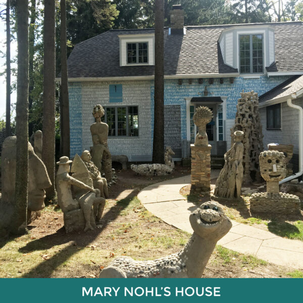 Mary Nohl’s House. A small house with cement sculptures of people and creatures among the tall trees in the yard. 