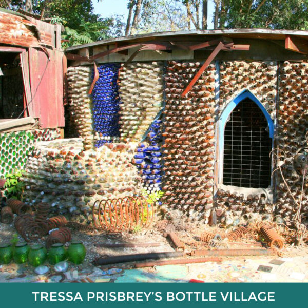 Tressa Prisbrey’s Bottle Village. A rounded building with walls created from stacked bottles. 