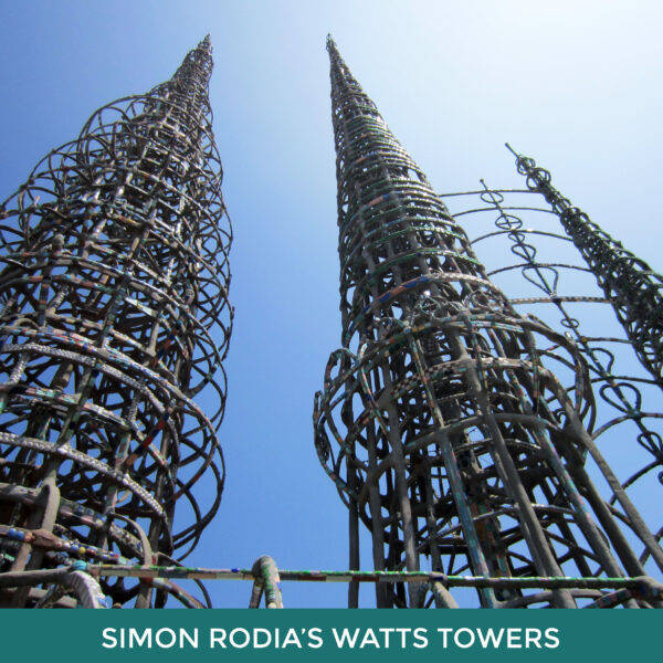 Simon Rodia’s Watts Towers. Three spiral towers made of steel and cement reach up towards a blue sky. 
