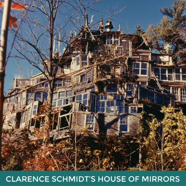 Clarence Schmidt’s House of Mirrors. A large building on a hillside made of a variety of windows. 