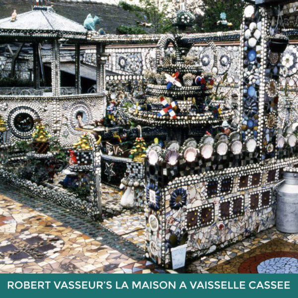 Robert Vasseur’s La Maison á Vaisselle Cassée. An outdoor courtyard decorated with ceramic plates and tiled mosaics. 