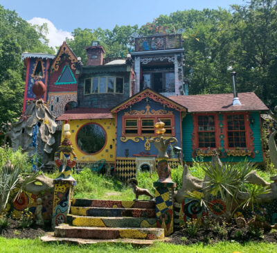 Ricky Boscarino's house with a variety of different sized and shaped windows and with many colors and adornments on it. 
