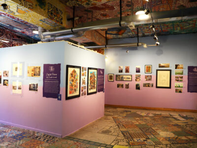 A view of the Back Gallery at Philadelphia's Magic Gardens with a variety of framed works of art on the walls.