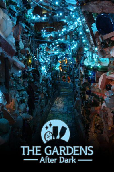 A sculptural hallway outside at Philadelphia's Magic Gardens illuminated by blue lights.
