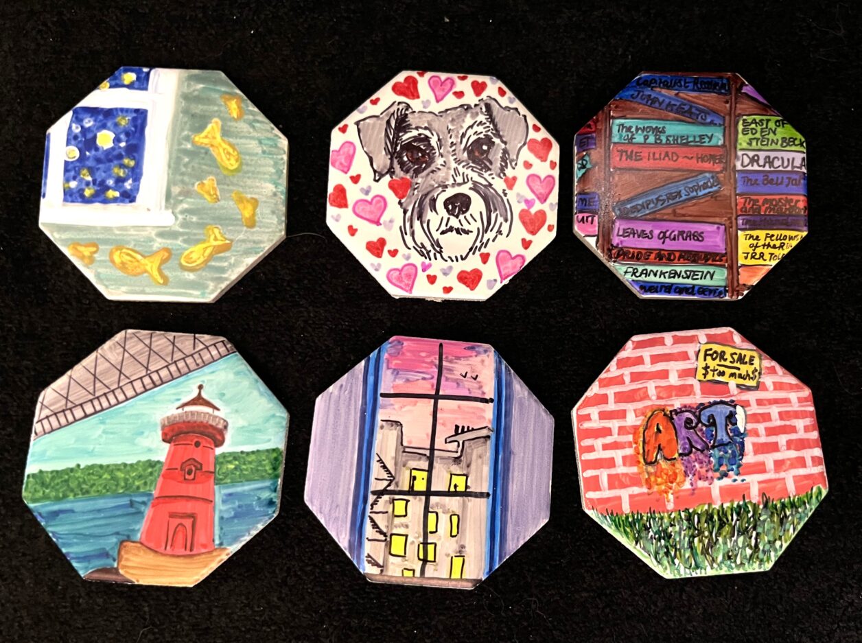 A group of six hexagonal tiles colored with a variety of pictures using sharpie markers.