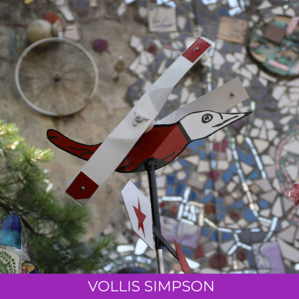 A metal bird painted white and red.