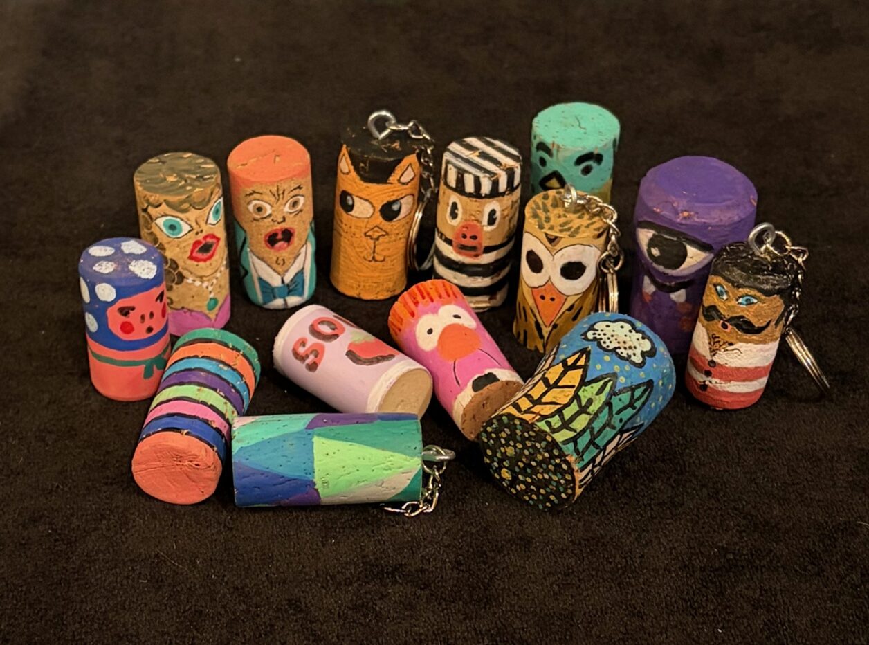 Corks painted to look like fun characters and colorful designs
