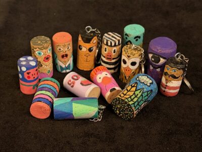 Corks painted to look like fun characters and colorful designs