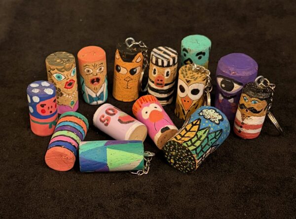 Corks painted to look like fun characters and colorful designs
