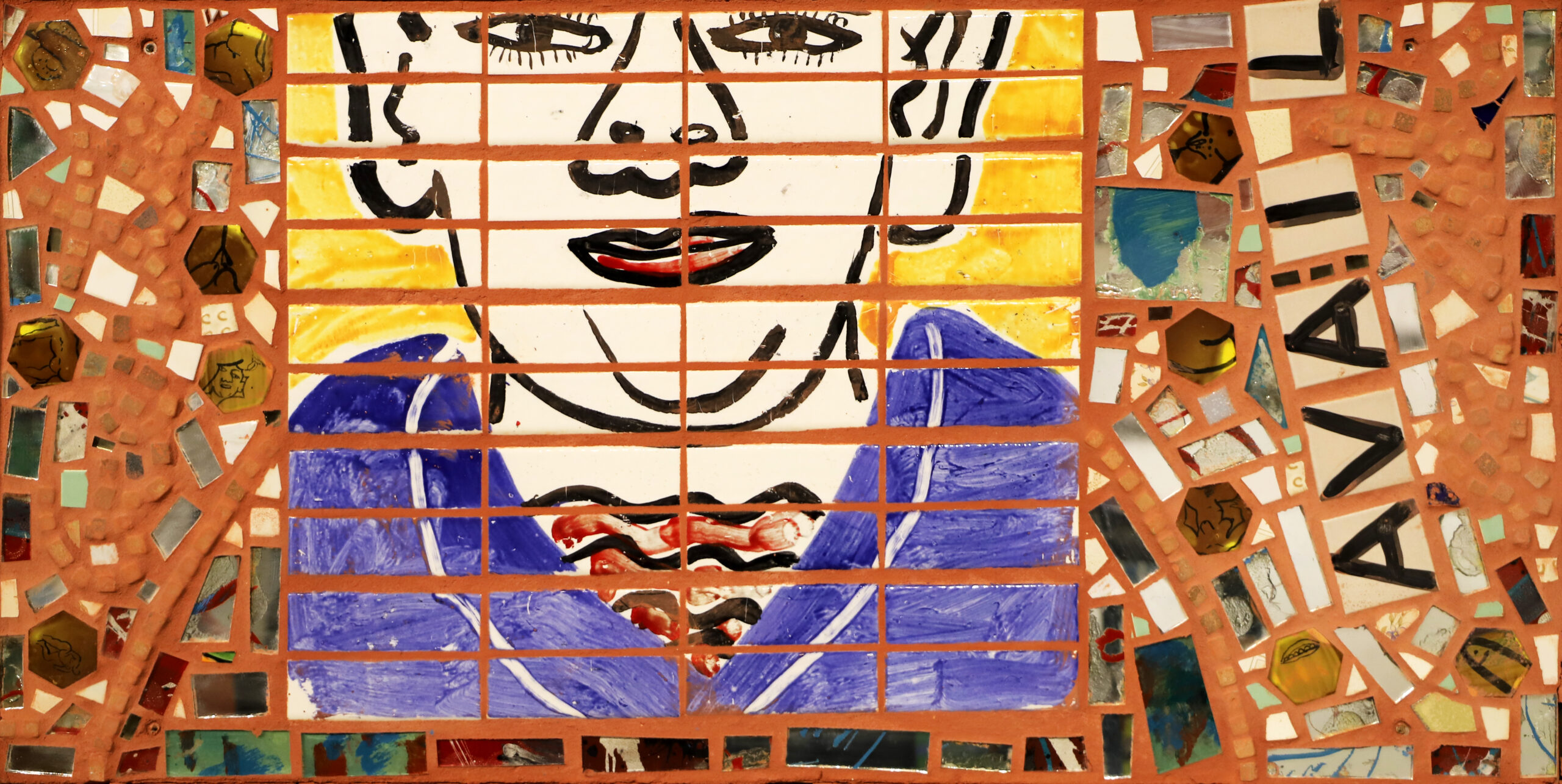 The image of a person in a blue shirt painted on tiles with orange grout in between the tiles. 