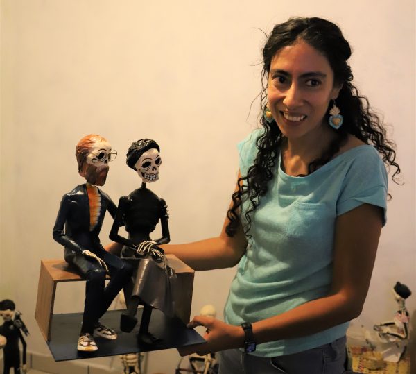 Ivette Chaires holds one of her papier-mache skeleton sculptures
